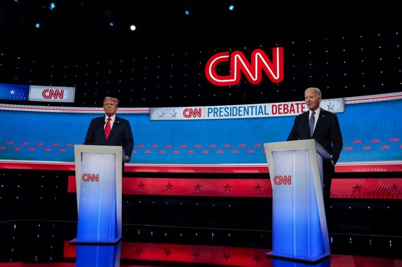 President Joe Biden and former president Donald Trump stand on the stage as CNN hosts an election debate in Atlanta, on Thursday. Photo by Elijah Nouvelage/UPI