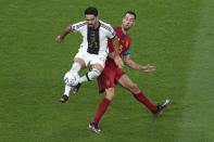 Germany's Ilkay Gundogan, left, controls the ball ahead of Spain's Sergio Busquets during the World Cup group E soccer match between Spain and Germany, at the Al Bayt Stadium in Al Khor, Qatar, Sunday, Nov. 27, 2022. (AP Photo/Ricardo Mazalan)