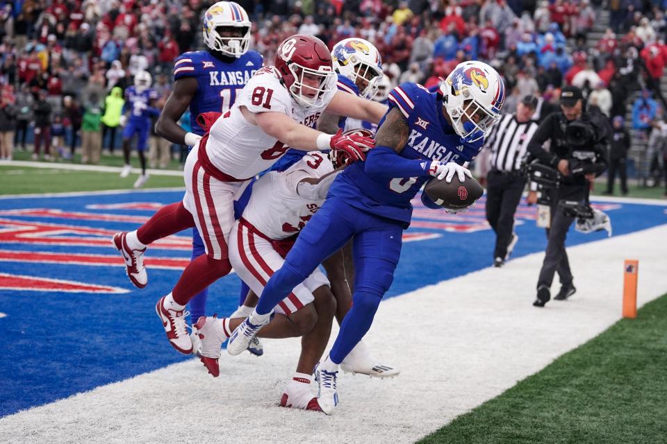 Kansas cornerback Kwinton Lassiter (8) tries to catch OU quarterback Dillon Gabriel's final pass Saturday out of the end zone to seal the Jayhawks' 38-33 win at David Booth Kansas Memorial Stadium in Lawrence, Kan.