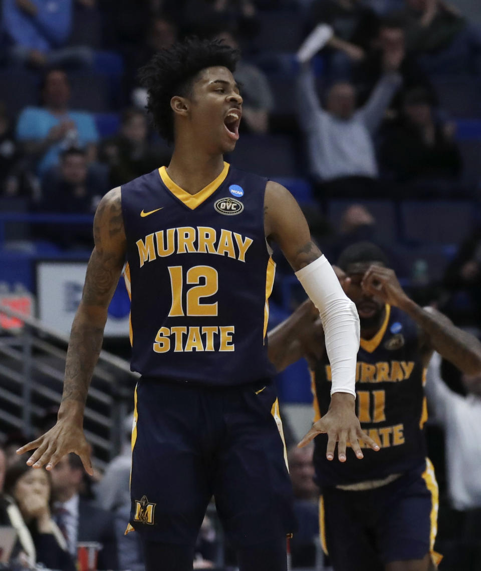 Murray State's Ja Morant (12) celebrates with Shaq Buchanan (11) during the second half of a first round men's college basketball game against Marquette in the NCAA Tournament, Thursday, March 21, 2019, in Hartford, Conn. (AP Photo/Elise Amendola)