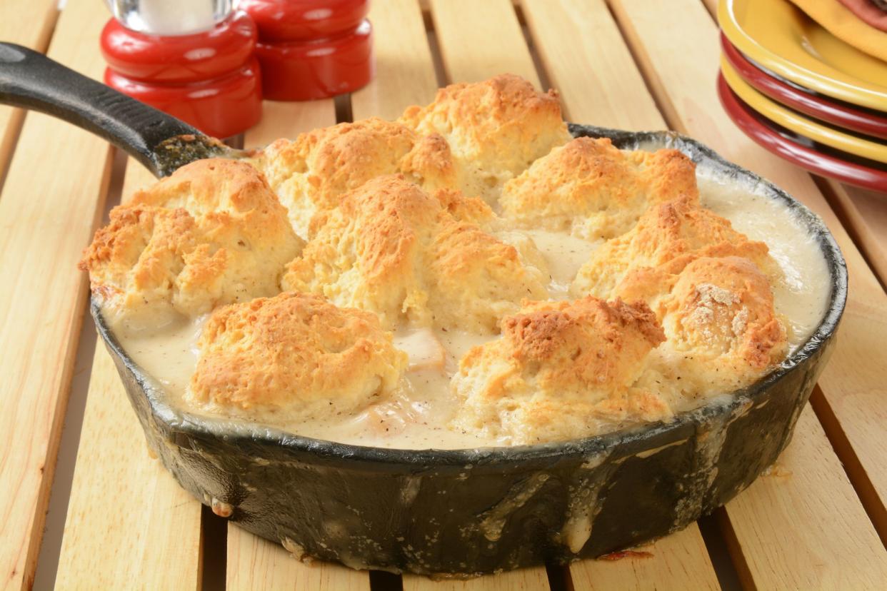 Home baked chicken pot pie with a biscuit crust in a cast iron skillet