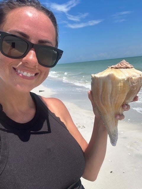 Jessica Crozier holds up a horse conch shell she found on Sanibel Island recently.