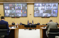 NATO Secretary General Jens Stoltenberg, center, speaks during a video conference of NATO Defense Minister at the NATO headquarters in Brussels, Wednesday, June 17, 2020. NATO Defense Ministers began two days of video talks focused on deterring Russian aggression and a US decision to withdraw thousands of troops from Germany. (Francois Lenoir, Pool Photo via AP)