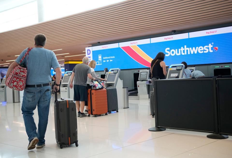 Traveler approaches the self-check-in kiosks for Southwest Airlines in Denver International Airport as the Labor Day holiday approaches Tuesday, Aug. 30, 2022, in Denver. (AP Photo/David Zalubowski)