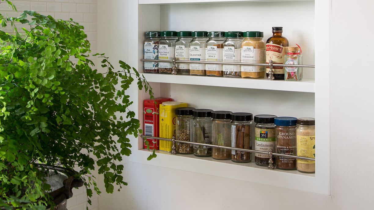 a white shelving unit with many jars of food on it