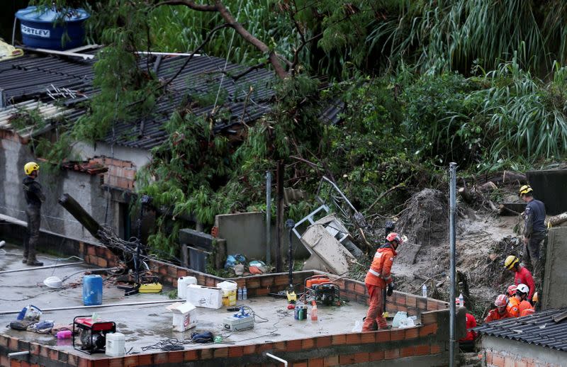 FILE PHOTO: Rescue workers search the site of a mudslide, after heavy rains at Vila Ideal neighborhood in Belo Horizonte