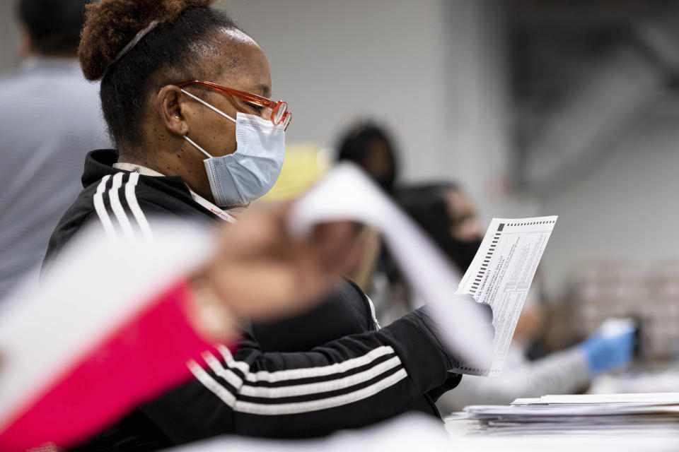 Workers at the Gwinnett County Georgia elections headquarters process absentee ballots for Georgia's Senate runoff election in Lawrenceville, Ga. on Wednesday, Jan. 6, 2021. (AP Photo/Ben Gray)