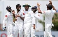 Cricket - Sri Lanka v India - First Test Match - Galle, Sri Lanka - July 27, 2017 - Sri Lanka's Nuwan Pradeep celebrates with his teammates after taking the wicket of India's Ravichandran Ashwin (not pictured). REUTERS/Dinuka Liyanawatte