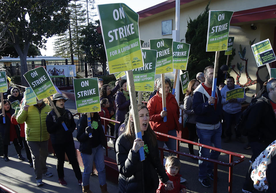 Teachers and supporters march outside of Manzanita Community School in Oakland, Calif., Thursday, Feb. 21, 2019. Teachers in Oakland, California, went on strike Thursday in the country's latest walkout by educators over classroom conditions and pay. (AP Photo/Jeff Chiu)