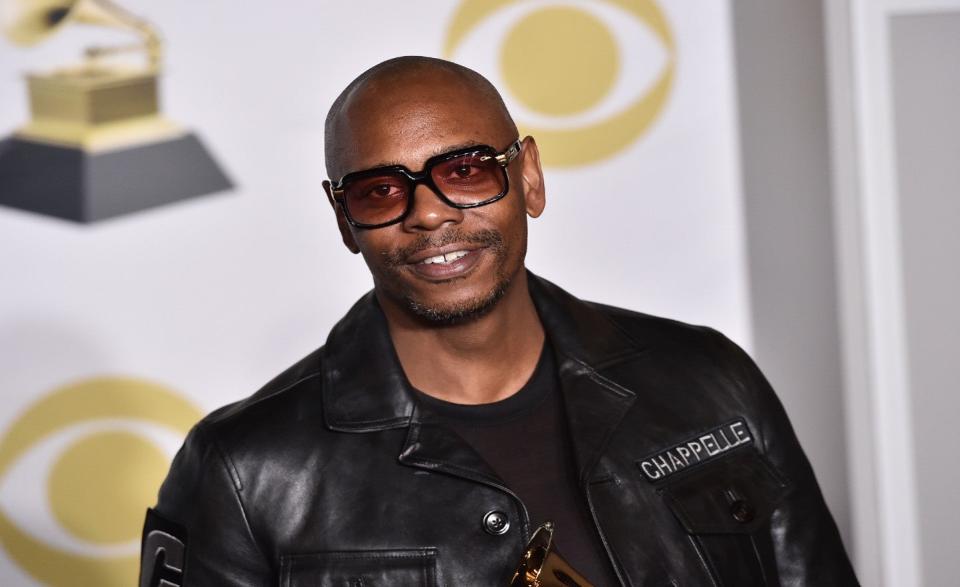 Dave Chappelle poses in the press room with the best comedy album award for “The Age of Spin” and “Deep in the Heart of Texas” at the 60th annual Grammy Awards in New York, Jan. 28, 2018. (Charles Sykes, Invision via Associated Press file)