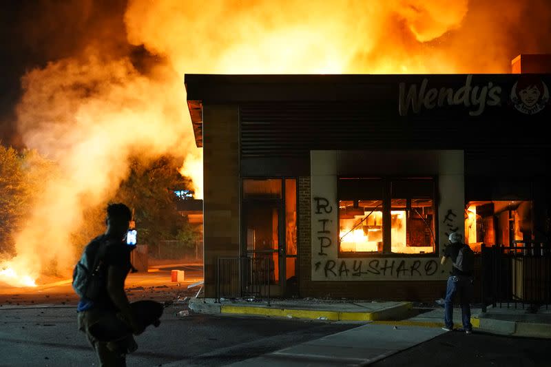 FILE PHOTO: A Wendy’s burns following a rally against racial inequality and the police shooting death of Rayshard Brooks, in Atlanta