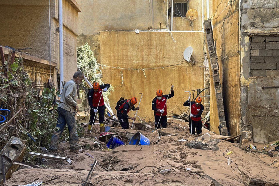 In this photo provided by Turkey's IHH humanitarian aid group, rescuers search for survivors and bodies of flooding victims in Derna, Libya, Wednesday, Sept.13, 2023. Search teams are combing streets, wrecked buildings, and even the sea to look for bodies in Derna, where the collapse of two dams unleashed a massive flash flood that killed thousands of people. (IHH via AP)