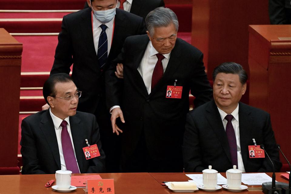 China's President Xi Jinping (R) sits besides Premier Li Keqiang (L) as former president Hu Jintao (C) is assisted to leave from the closing ceremony of the 20th China's Communist Party's Congress at the Great Hall of the People in Beijing on October 22, 2022. (Photo by Noel Celis / AFP) (Photo by NOEL CELIS/AFP via Getty Images)