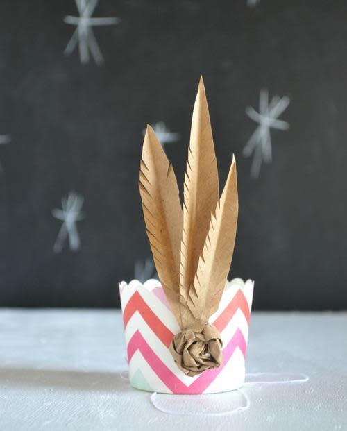 paper crown with feather inside