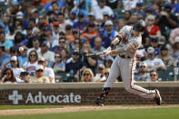 San Francisco Giants' Mike Yastrzemski hits a two-run single off Chicago Cubs relief pitcher Manuel Rodriguez during the fifth inning of a baseball game, Saturday, Sept. 11, 2021, in Chicago. (AP Photo/Kamil Krzaczynski)