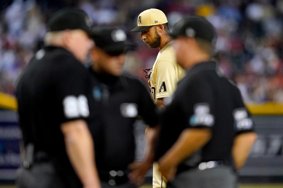 Arizona Diamondbacks' starting pitcher Madison Bumgarner waits to pitch as the umpires confer during the third inning of a baseball game agaisnt the San Diego Padres, Friday, Sept. 16, 2022, in Phoenix. (AP Photo/Matt York)