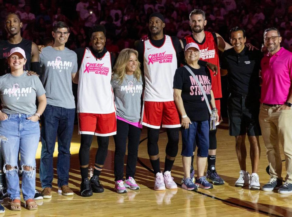 Miami Heat’s Kyle Lowry (7), Jimmy Butler (22), Duncan Robinson (55) and head coach Erik Spoelstra are photographed alongside breast cancer survivors and their doctors before the start of the Miami Heat’s Red, White & Pink intrasquad scrimmage game at the Kaseya Center on Monday, Oct. 9, 2023, in downtown Miami, Fla.