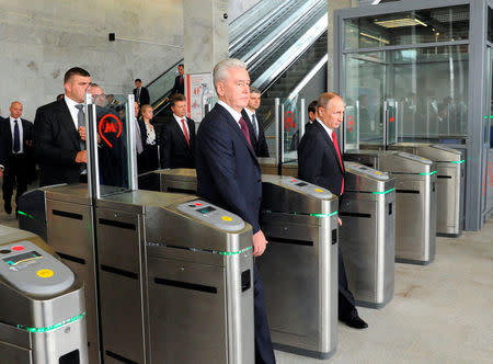 Russian President Vladimir Putin (R) and Moscow Mayor Sergei Sobyanin (C) enter a station as they attend the opening of the Central Ring line in Moscow, Russia September 10, 2016. Sputnik/Kremlin/Mikhail Klimentyev/via REUTERS