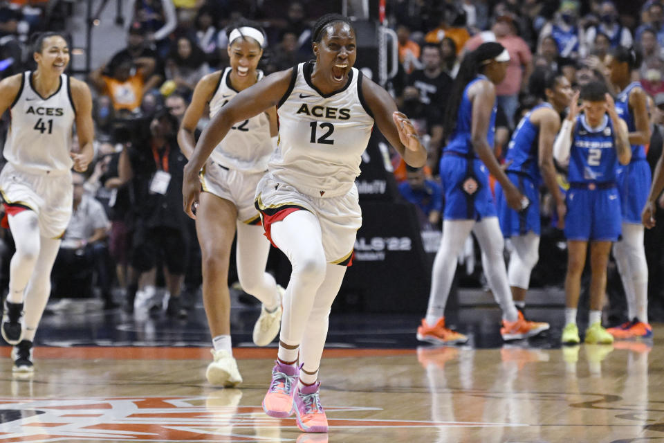 Las Vegas Aces' Chelsea Gray (12) celebrates with her team their win in the WNBA basketball finals against the Connecticut Sun, Sunday, Sept. 18, 2022, in Uncasville, Conn. (AP Photo/Jessica Hill)