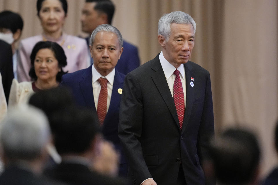Singapore's Prime Minister Lee Hsien Loong, right, walks in front of Malaysia Speaker of the House of Representatives Azhar Azizan Harun, as they arrives for the opening ceremony of the 40th and 41st ASEAN Summits (Association of Southeast Asian Nations) in Phnom Penh, Cambodia, Friday, Nov. 11, 2022. The ASEAN summit kicks off a series of three top-level meetings in Asia, with the Group of 20 summit in Bali to follow and then the Asia Pacific Economic Cooperation forum in Bangkok.(AP Photo/Vincent Thian)