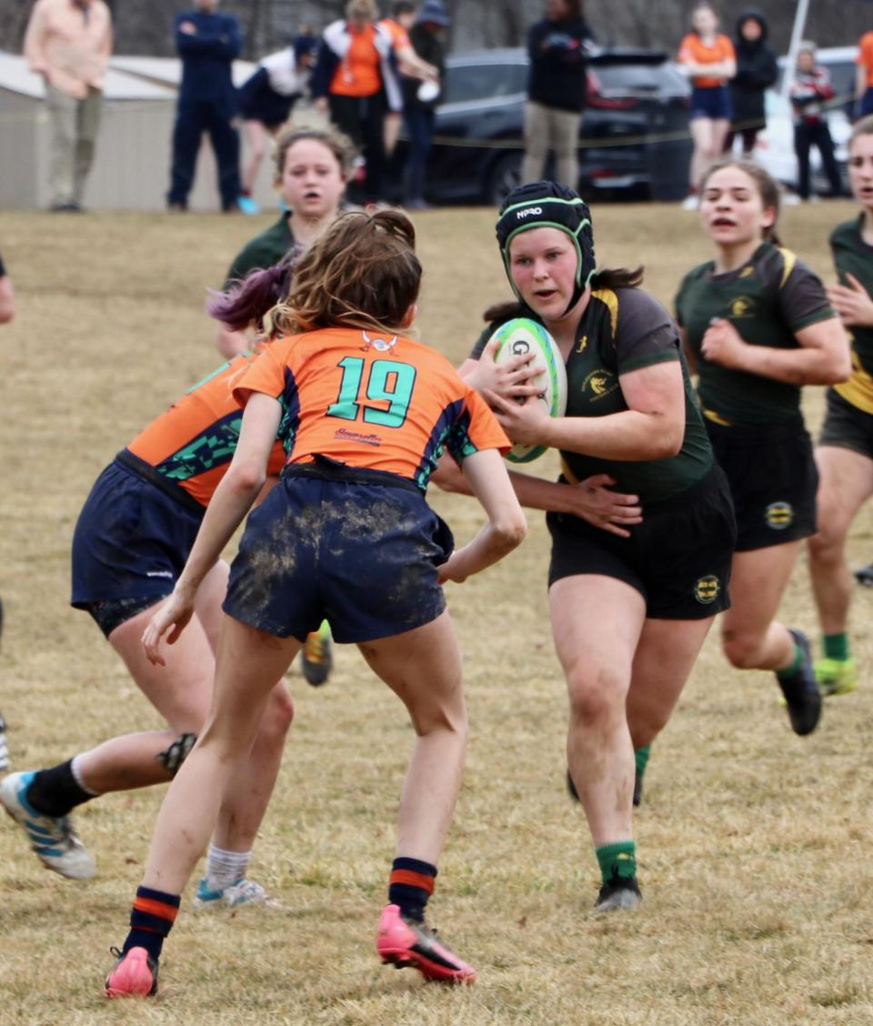 Reaghan King of Smyrna runs with the ball while playing rugby for the Doylestown Dragons.