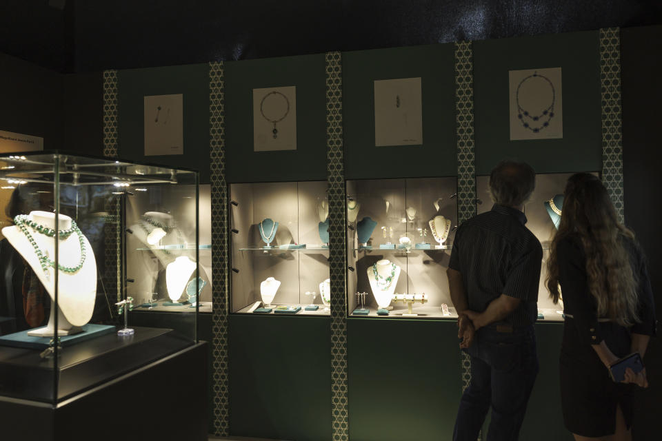 Visitors look of the Bulgari jewels displayed in display case during the exhibition of "The World of Heidi Horten" the 700 piece jewellery collection of the late Austrian billionaire Heidi Horten, at Christie's Auction House in Geneva, Switzerland, Monday, May 8, 2023. (Salvatore Di Nolfi/Keystone via AP)