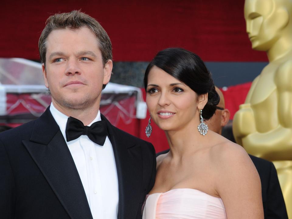 matt damon and luciana barroso pose on the oscars red carpet in formal attire