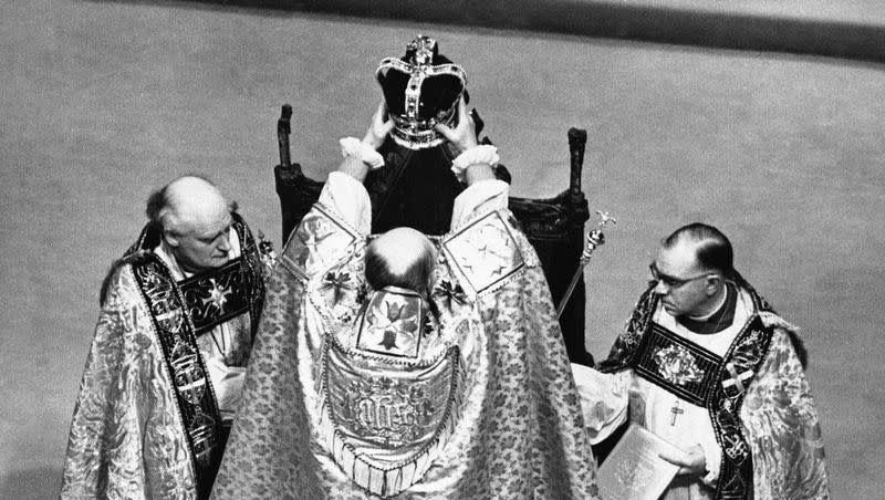 The Archbishop of Canterbury holds the ritual crown of England, the crown of St. Edward, over the head of Queen Elizabeth II, during the coronation ceremonies in Westminster Abbey, London on June 2, 1953.