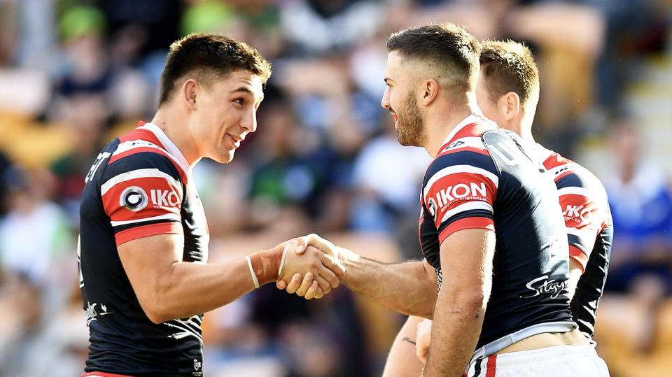 James Tedesco shakes hands with teammate Victor Radley.