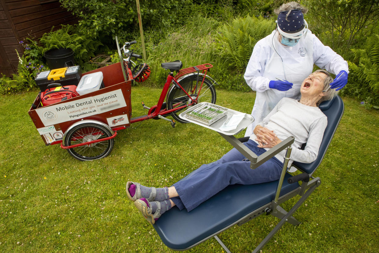 Fiona Perry works on 89-year-old Jean Temple in her garden. (SWNS)