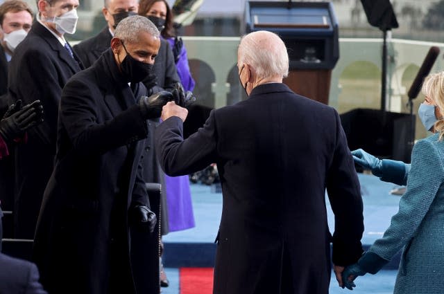 Joe Biden bumps fists with former president Barack Obama during Mr Biden’s inauguration at the US Capitol in Washington