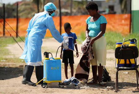 Medical staff spray disinfectant at a cholera treatment centre set up in the aftermath of Cyclone Idai in Beira, Mozambique, March 29, 2019. REUTERS/Mike Hutchings