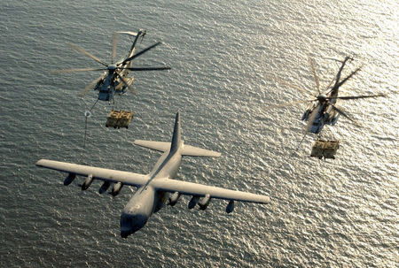 FILE PHOTO: Two U.S. Marine Corps CH-53E Super Stallion helicopters receive fuel from a KC-130 Hercules over the Gulf of Aden January 1, 2003. U.S. Marine Corps/Cpl. Paula M. Fitzgerald/Handout/File Photo via REUTERS