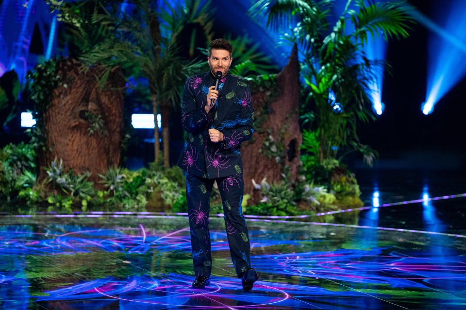 Joel Dommett wears a suit covered in illustrations of spiders