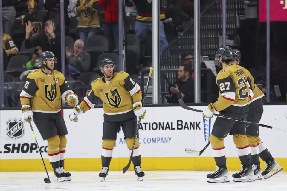 Vegas Golden Knights center William Karlsson, left, celebrates with right wing Jonathan Marchessault (81) after Marchessault's goal against the Toronto Maple Leafs during the third period of an NHL hockey game Thursday, Feb. 22, 2024, in Las Vegas. (AP Photo/Ian Maule)