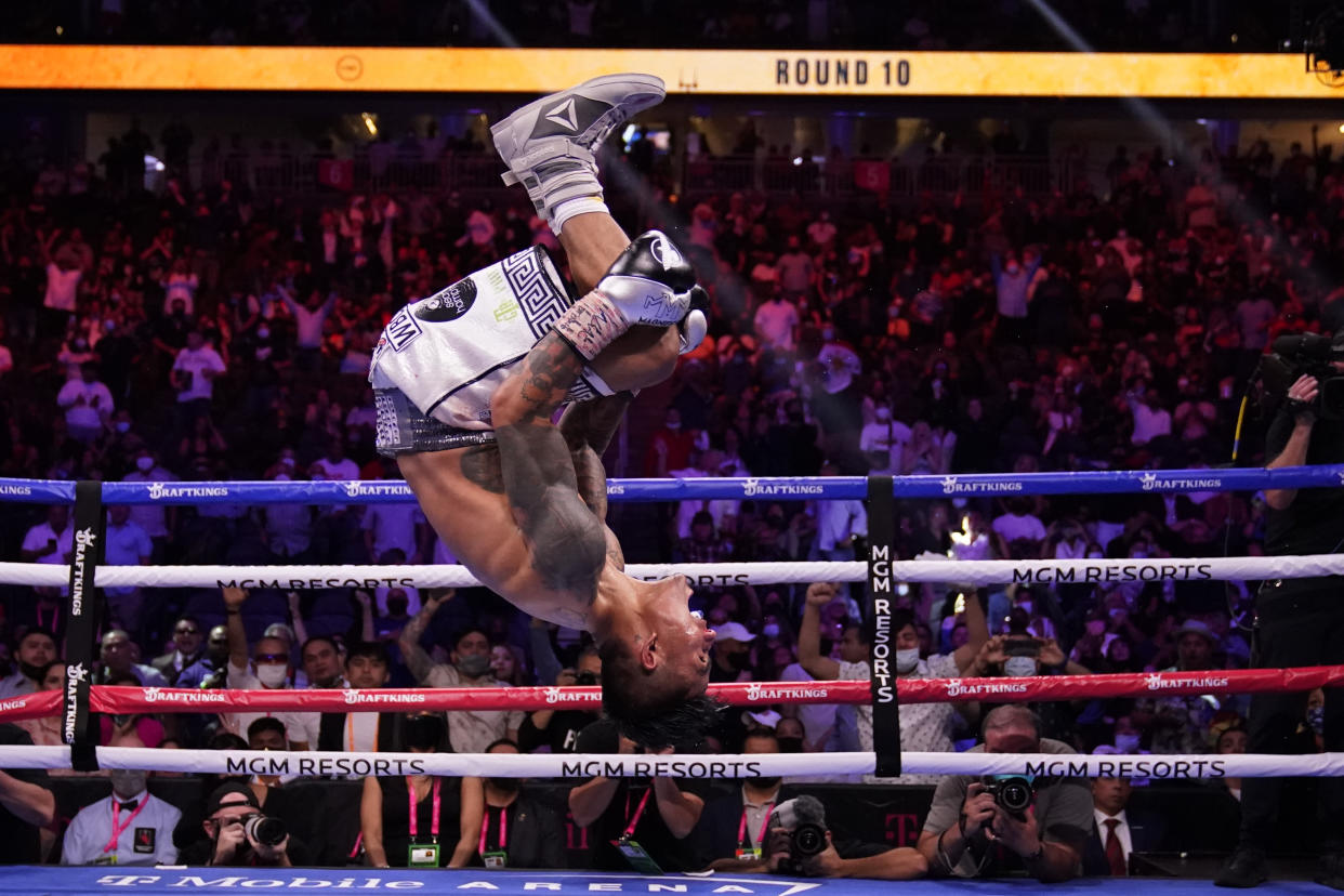 Mark Magsayo, of the Philippines, celebrates after knocking out Julio Ceja, of Mexico, in the 10th round of a featherweight boxing match Saturday, Aug. 21, 2021, in Las Vegas. (AP Photo/John Locher)