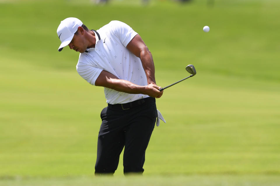 Brooks Koepka chips to the fourth green during the first round of the Tour Championship golf tournament Friday, Aug. 23, 2019, in Atlanta. (AP Photo/John Amis)