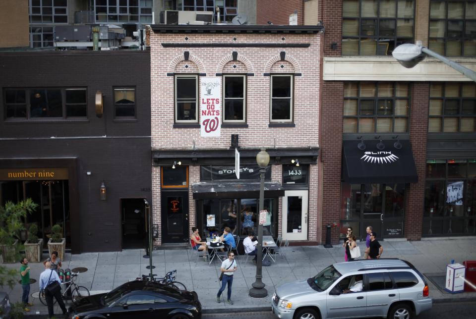 This July 30, 2013 photo shows people dining outside of Stoney's Lounge in Washington. Stoney's is located in the Logan Circle neighborhood of Washington. (AP Photo/Pablo Martinez Monsivais)