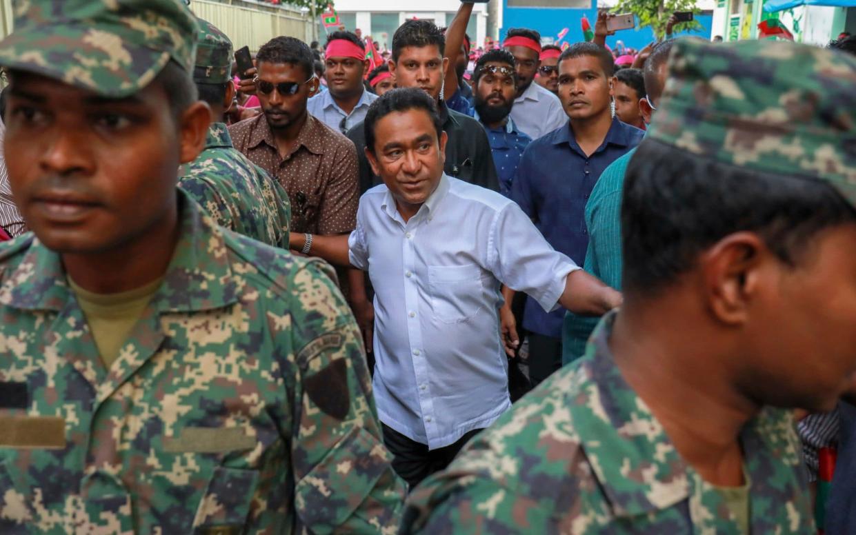 President Yameen Abdul Gayoom, center, surrounded by his body guards arrives to address his supporters in Male, Maldives - AP