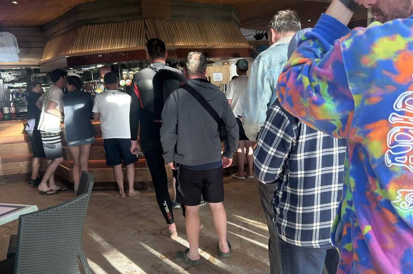 The single file queue at The Watering Hole in Perranporth