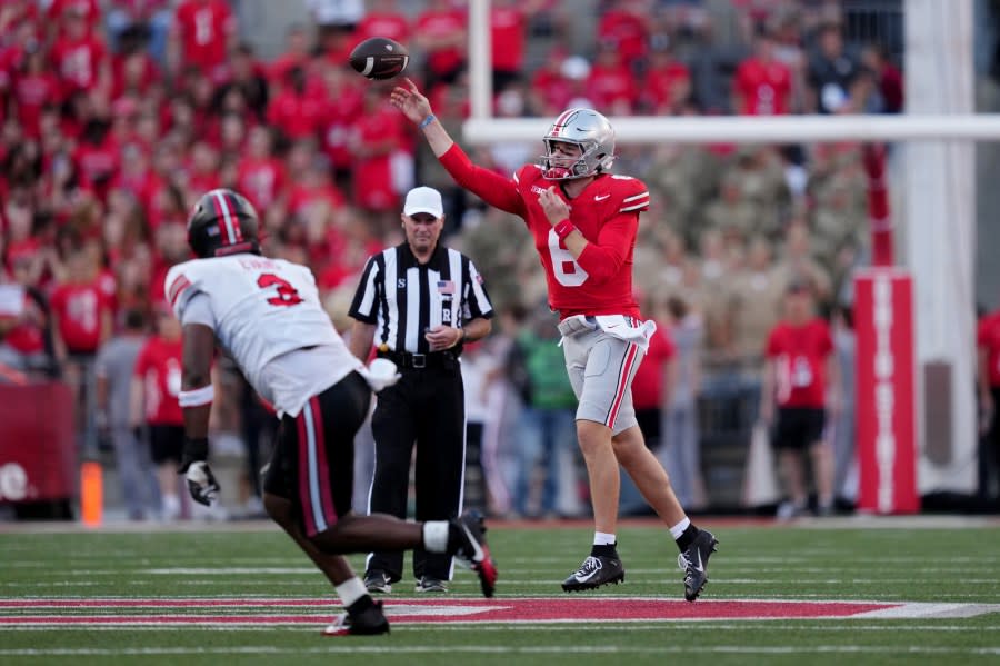 COLUMBUS, OHIO – SEPTEMBER 16: Kyle McCord #6 of the Ohio State Buckeyes throws a pass while being chased by JaQues Evans #3 of the Western Kentucky Hilltoppers in the second quarter at Ohio Stadium on September 16, 2023 in Columbus, Ohio. (Photo by Dylan Buell/Getty Images)