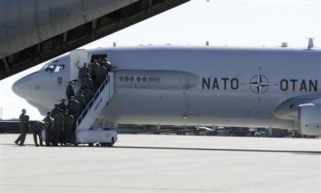 Airmen board a NATO AWACS (Airborne Warning and Control Systems) aircraf during a joint NATO military exercise in Siauliai April 1, 2014. The NATO alliance said it will start reconnaissance flights with AWACS planes from their home base in Geilenkirchen and Waddington in Britain over Poland and Romania to monitor the situation in neighbouring Ukraine where Russian forces have taken control of Crimea. REUTERS/Ints Kalnins