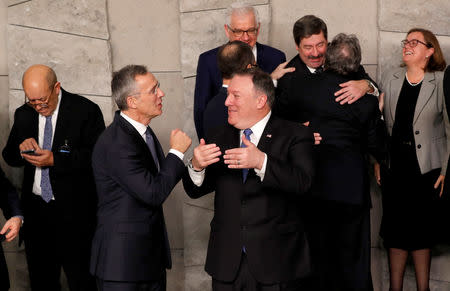 NATO's Secretary General Jens Stoltenberg and U.S. Secretary of State Mike Pompeo gesture as they speak before posing for a family photo during the NATO foreign ministers' meeting at the Alliance's headquarters in Brussels, Belgium, December 4, 2018. REUTERS/Yves Herman