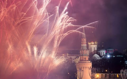 Fireworks explode in the sky during New Year's celebrations in Moscow - Credit: Reuters