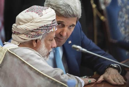 Oman's Foreign Minister Yusuf Bin Alawi bin Abdullah and U.S. Secretary of State John Kerry talk before the start of a Gulf Cooperation Council and Regional Partners meeting in Jeddah September 11, 2014. REUTERS/Brendan Smialowski/Pool