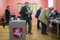 Local residents votes at a polling station during a first round of voting in presidential elections in Vilnius, Lithuania, Sunday, May 12, 2024. (AP Photo/Mindaugas Kulbis)