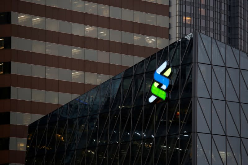 A logo of Standard Chartered is displayed at the financial Central district in Hong Kong