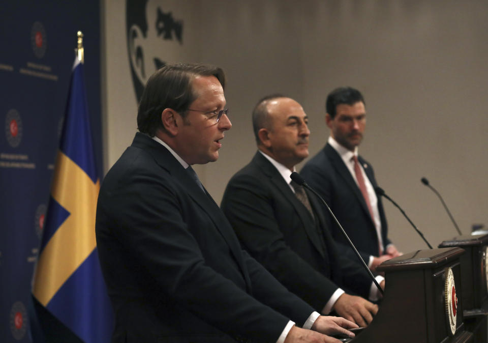 Turkey's Foreign Minister Mevlut Cavusoglu, centre, European Commissioner for Neighbourhood and Enlargement Oliver Varhelyi, left, and Sweden's Minister for International Development Cooperation and Foreign Trade Johan Forssell speak at a joint news conference in Ankara, Turkey, Wednesday, Feb. 22, 2023. Varhelyi and Forssell are in town to prepare for the International Donor's Conference, scheduled for March in Brussels, and aimed at mobilizing funds from the international community to support Turkey and Syria following the quakes.(AP Photo/Burhan Ozbilici)