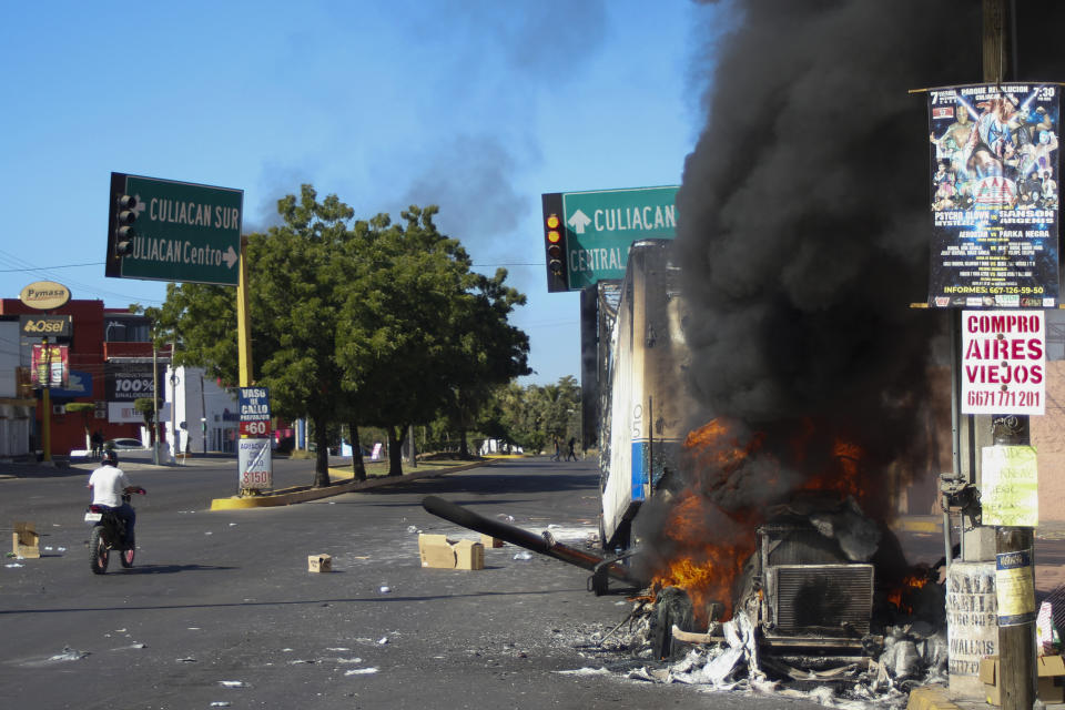 FILE - A truck burns after being set on fire in Culiacan, Sinaloa state, Mexico, Jan. 5, 2023, the day the government detained Ovidio Guzman, the son of imprisoned drug lord Joaquin "El Chapo" Guzman, which unleashed deadly firefights between the military and suspected members of the Sinaloa drug cartel. With Sinaloa cartel boss Joaquín “El Chapo” Guzmán serving a life sentence, his sons steered the family business into fentanyl, establishing a network of labs churning out massive quantities they smuggled into the U.S., prosecutors in the U.S. revealed in an indictment unsealed April 14, 2023 in Manhattan. (AP Photo/Martin Urista, File)