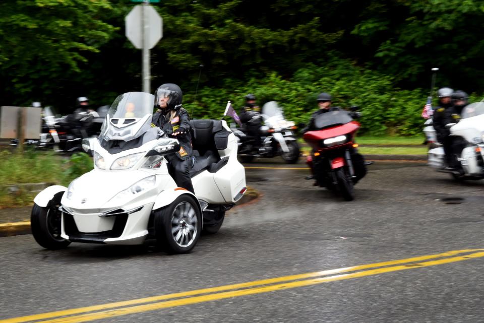 The motorcade depart the Kitsap County Administration Building to escort the unclaimed remains of five deceased veterans to Tahoma National Cemetery on May 28, 2022.